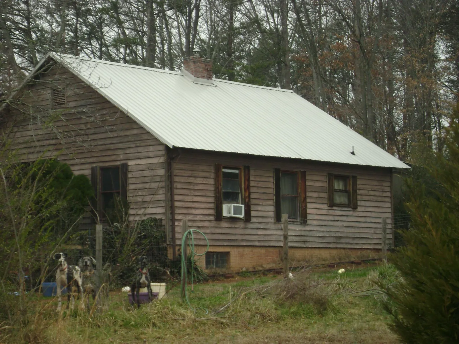 White metal roof on an old wood sided farmhouse, from a Metal Roof Installation job in Bellerose